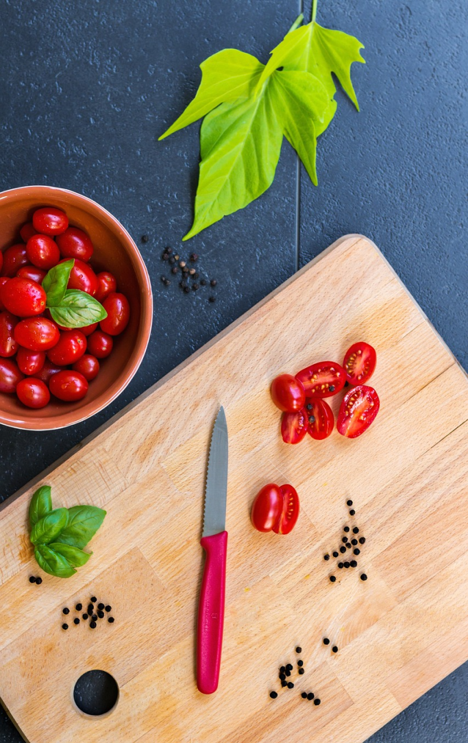 Cut vegetables on a cutting board with a knife